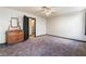 Large bedroom with a ceiling fan, neutral carpeting, and closet access at 4932 Goldeneye Way, North Las Vegas, NV 89031