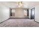 Spacious bedroom featuring a ceiling fan, large windows for ample natural light, and neutral carpeting at 4932 Goldeneye Way, North Las Vegas, NV 89031