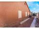 Home exterior showing stucco siding, a red-tiled roof, and a clean, gravel side yard at 4932 Goldeneye Way, North Las Vegas, NV 89031