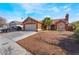 Charming single-story home featuring desert landscaping, a tile roof and an attached two-car garage at 4932 Goldeneye Way, North Las Vegas, NV 89031