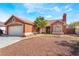 Charming single-story home featuring desert landscaping, a tile roof and an attached two-car garage at 4932 Goldeneye Way, North Las Vegas, NV 89031