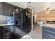 Kitchen area features dark appliances, granite countertops, and plank wall in distance at 4932 Goldeneye Way, North Las Vegas, NV 89031