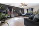 Comfortable living room features fireplace, neutral tile flooring, dark walls, and natural light at 4932 Goldeneye Way, North Las Vegas, NV 89031