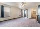 Bright primary bedroom with a ceiling fan, closet, and generous natural light from two windows at 4932 Goldeneye Way, North Las Vegas, NV 89031