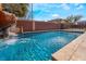 Backyard pool with a large rock waterfall and slide feature for endless summer fun and relaxation at 4932 Goldeneye Way, North Las Vegas, NV 89031