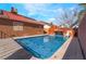 Outdoor pool with rock waterfall, solar panels, and a textured deck for easy lounging at 4932 Goldeneye Way, North Las Vegas, NV 89031