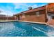 Relaxing outdoor pool featuring a rock waterfall, solar panels and a spacious backyard at 4932 Goldeneye Way, North Las Vegas, NV 89031