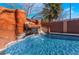 Beautiful pool features a custom rock waterfall, adding a touch of nature to your backyard oasis at 4932 Goldeneye Way, North Las Vegas, NV 89031