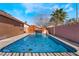 Sparkling pool features a rock waterfall feature, unique turtle details, and a sun-soaked patio area at 4932 Goldeneye Way, North Las Vegas, NV 89031