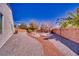 This backyard features low maintenance landscaping and a private brick wall at 5295 Acqua Ln, Pahrump, NV 89061