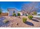 Charming single-story home featuring desert landscaping and a well-maintained yard, under a clear blue sky at 5295 Acqua Ln, Pahrump, NV 89061