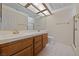 Bathroom with double sinks, tiled floor, and a large mirror and vanity at 544 Cervantes Dr, Henderson, NV 89014