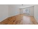 A large bedroom featuring sleek, laminate floors, a large window, and neutral walls at 544 Cervantes Dr, Henderson, NV 89014