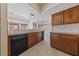 View of the kitchen with wood cabinets and black appliances at 544 Cervantes Dr, Henderson, NV 89014