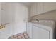 Functional laundry room with washer, dryer and white cabinets at 544 Cervantes Dr, Henderson, NV 89014