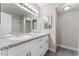 Bright bathroom featuring a double sink vanity with granite counters and a framed mirror at 5939 Vegas Dr, Las Vegas, NV 89108