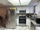 Modern kitchen with stainless steel appliances, white cabinets and gray countertop at 5939 Vegas Dr, Las Vegas, NV 89108