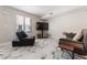 Cozy living area with comfortable seating, a large window, and marble-style tile flooring at 5939 Vegas Dr, Las Vegas, NV 89108