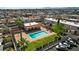 Aerial view of the community pool with clear water and a lounging area, surrounded by well-maintained landscaping and parking at 5939 Vegas Dr, Las Vegas, NV 89108