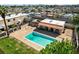 A clear swimming pool is nestled in a multi-Gathering property with a tiled roof structure and lounge area at 5939 Vegas Dr, Las Vegas, NV 89108