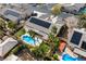 Aerial view of home featuring a large pool, an orange sport court, solar panels, and desert landscaping at 5968 Saint Lazare St, Las Vegas, NV 89130