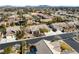 An aerial view shows the neighborhood with mature trees, multiple residential homes, and mountain views in the distance at 5968 Saint Lazare St, Las Vegas, NV 89130