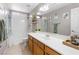 Bathroom with tile floors, long vanity, and a shower-tub combo with natural plants and decor at 5968 Saint Lazare St, Las Vegas, NV 89130