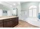 Bright bathroom features a large walk-in shower, soaking tub and a granite-topped vanity at 5968 Saint Lazare St, Las Vegas, NV 89130