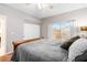 Bedroom featuring plush gray comforter, tan carpet, and natural light from a window with white shutters at 5968 Saint Lazare St, Las Vegas, NV 89130