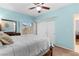 Light and airy bedroom featuring plush carpet, a ceiling fan, and built-in closet and shelf space at 5968 Saint Lazare St, Las Vegas, NV 89130