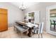 Cozy dining area with a wooden table, stylish chairs, and a sliding door to the patio at 5968 Saint Lazare St, Las Vegas, NV 89130