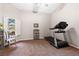 Carpeted bonus room featuring a treadmill, a window with shutters, and modern decor at 5968 Saint Lazare St, Las Vegas, NV 89130