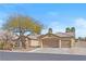 Well-maintained home with a three car garage, desert landscaping and a charming desert tree in the front yard at 5968 Saint Lazare St, Las Vegas, NV 89130