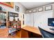 Functional home office with built-in shelves, wooden desk, and neutral wall colors at 5968 Saint Lazare St, Las Vegas, NV 89130