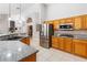 Modern kitchen featuring stainless steel appliances, granite countertops, and wooden cabinetry at 5968 Saint Lazare St, Las Vegas, NV 89130