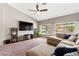 Comfortable living room with plush seating, a vaulted ceiling, and view of the backyard at 5968 Saint Lazare St, Las Vegas, NV 89130