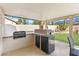 An outdoor kitchen with built-in grill, countertop space, beverage cooler, and a beer dispenser for entertaining at 5968 Saint Lazare St, Las Vegas, NV 89130