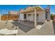 Backyard featuring a covered patio and desert landscaping with a partial view of the house at 6412 Yarmouth Dr, Las Vegas, NV 89108