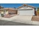 Well-kept single-story home with a two-car garage, desert landscaping, and a cozy front entrance at 6412 Yarmouth Dr, Las Vegas, NV 89108