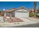 Single-Gathering home features a two-car garage, stucco exterior, covered porch, and low-maintenance landscaping at 6412 Yarmouth Dr, Las Vegas, NV 89108