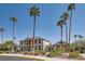 Exterior view of a suburban community building with tall palm trees, blue sky, and desert landscaping at 6412 Yarmouth Dr, Las Vegas, NV 89108