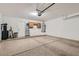 Spacious garage with sealed concrete floor, cabinets, and a garage door opener at 6412 Yarmouth Dr, Las Vegas, NV 89108