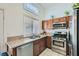 Functional kitchen with stainless steel appliances, granite countertops, and a bright window view at 6412 Yarmouth Dr, Las Vegas, NV 89108