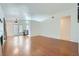 Bright living room featuring beautiful wood floors and a doorway into the kitchen at 6412 Yarmouth Dr, Las Vegas, NV 89108