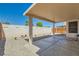 Covered patio featuring pavers, a rock wall, and desert landscaping in the backyard at 6412 Yarmouth Dr, Las Vegas, NV 89108