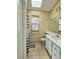 This bathroom has a sink, mirror, white cabinetry, and toilet with an interesting decorative touch at 6632 Ives Ave, Las Vegas, NV 89108