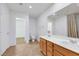 Bright bathroom with double vanity, tiled floors, and walk-in closet access at 7083 Mackenzie Bay Ave, Las Vegas, NV 89179