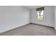 Bare bedroom featuring plush carpeting and a window at 7083 Mackenzie Bay Ave, Las Vegas, NV 89179