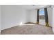 Neutral bedroom offering a blank canvas with soft carpet and natural light from the window at 7083 Mackenzie Bay Ave, Las Vegas, NV 89179