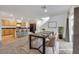 Dining area connected to the kitchen, featuring a modern table setting and an open, airy layout. (Virtually Staged) at 7083 Mackenzie Bay Ave, Las Vegas, NV 89179